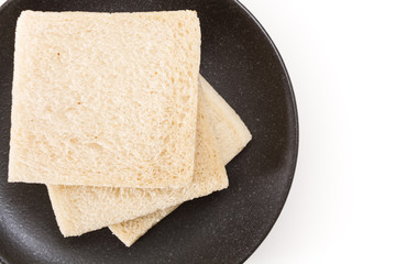 White sandwich bread slices on plate, on white background.