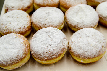 Donuts sprinkled with powdered sugar.