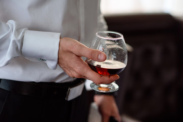 Hand, a glass of cognac