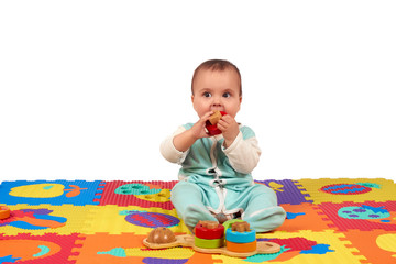 baby girl playing wooden toy blocks isolated on Soft mat