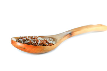 wood spoon with rice white and brown select focus with shallow depth of field.
