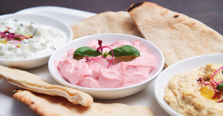 restaurant starter meal of a sharing platter of dips with bread