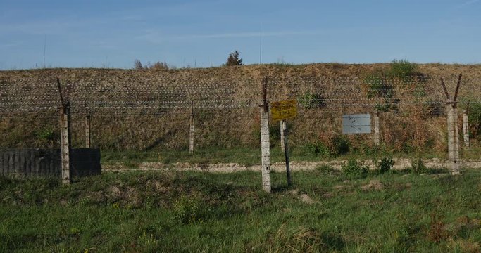 Camera Approaching Some Yellow Sing With an Inscription 'forbidden Zone' Which is Installed Behind Some Barbed Wite Fence and a Gueard Tower in Ukraine