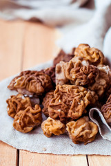 Mushrooms morel on a linen tablecloth and wooden background.