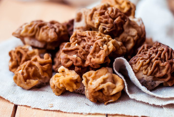 Mushrooms morel on a linen tablecloth and wooden background.