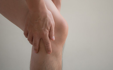Man working injured leg with calf feeling pain.