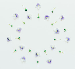 floral round frame of small blue flowers on a white background with space for text. Flat lay, top view