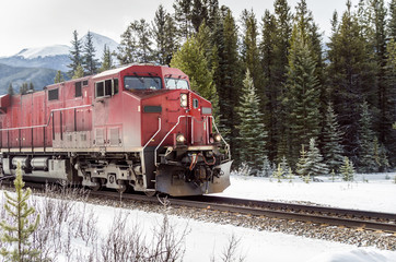 Locomotive in Motion through a Snowy Forest on a Winter Day