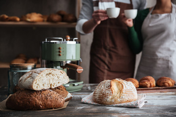 Loving couple bakers drinking coffee.