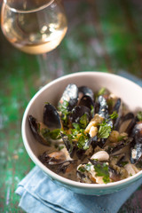Mussels in Roquefort sauce  on the blurred background vertical
