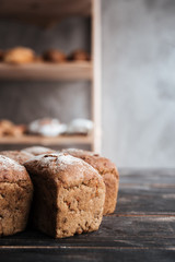 Bread with flour on dark wooden table