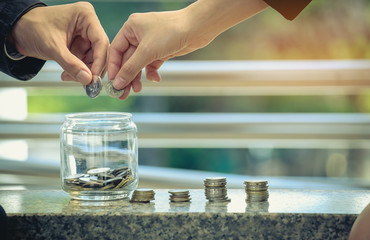 The couple's hands together to save money for the future to stand together. Future planning concepts