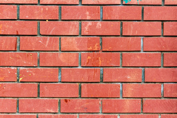 Wall of red brick with dirty spots. Abstract background