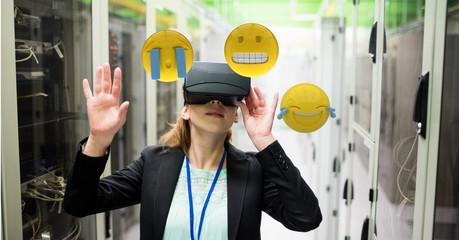 Woman looking at emojis through VR glasses