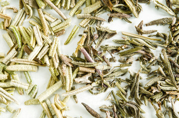 Dry leaves of thyme and rosemary isolated on white. Food background. Closeup macro shot. Top view.