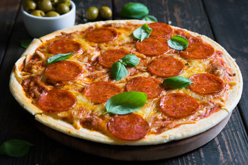 Pizza with pepperoni and basil
