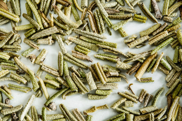 Dry leaves of rosemary. Food background. Closeup macro shot. Top view.
