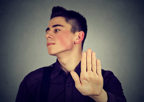 Annoyed man with bad attitude giving talk to hand gesture