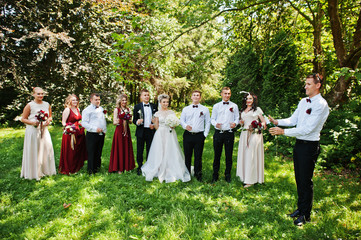 Elegance wedding couple with bridesmaids and best mans drinking champagne.