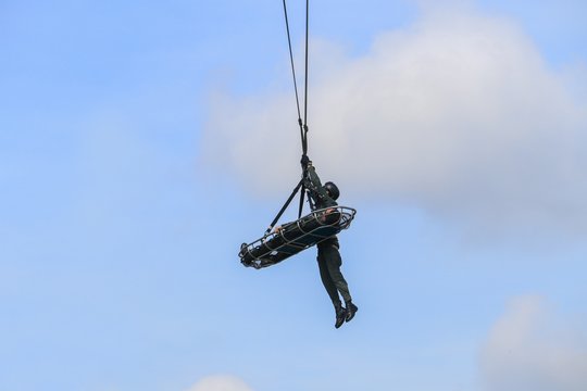 Soldier rescue emergency by army helicopter with rope  on blue sky
