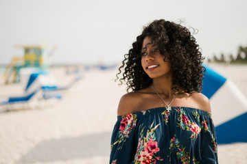 Fashion woman walking on beach with a summer dress