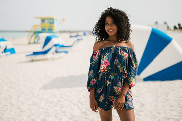 Fashion woman walking on beach with a summer dress