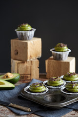 chocolate cupcakes with avocado cream on wood cubes