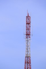 Telecommunication tower red and white antenna radio telephone mobile on sky background