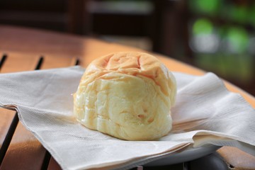 bread  in paper napkin on a wooden table