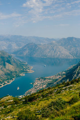 Bay of Kotor from the heights. View from Mount Lovcen to the bay. View down from the observation platform on the mountain Lovcen. Mountains and bay in Montenegro. The liner near the old town of Kotor.