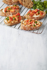 four brown bread sandwiches with tomatoes and shrimps