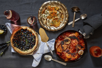 food still life of three courses and blueberry and lemon cocktail