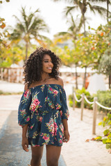 Naklejka premium Fashion woman walking on beach with a summer dress