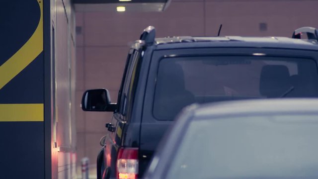 Man's hand paying in cash in auto fast food