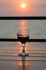 A glass of wine at sunset