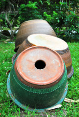 Three used clay pots in the garden.