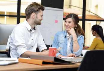 Young businesspersons working together in the office with a laptop computer