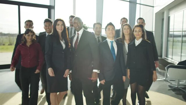  Portrait smiling diverse business group in large modern office building