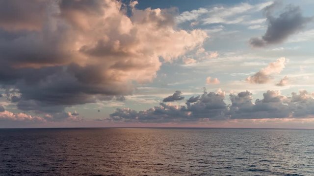 a beautiful sunrise on the horizon at sea filmed from a boat in the Mediterranean