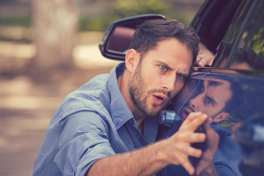 Worried funny looking man obsessing about cleanliness of his new car