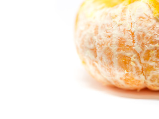 Closeup of peeled orange on white background