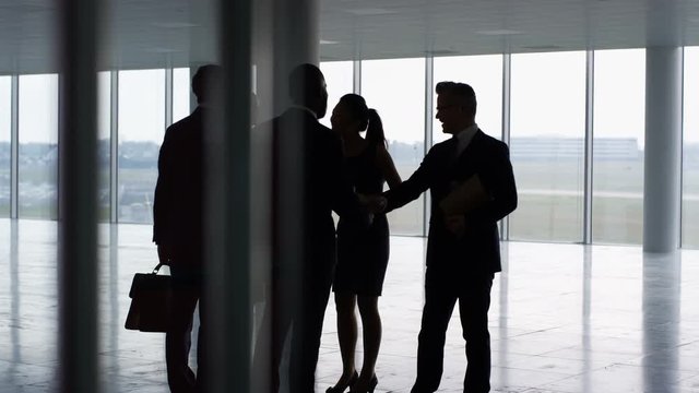  Business team viewing empty commercial property & shaking hands with agents