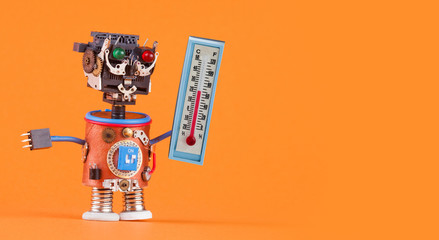 Weathermen robot with thermometer displaying comfort room temperature 21 degree celsius. Weather forecasting concept photo. Funny head robotic toy character on orange background, copy space.