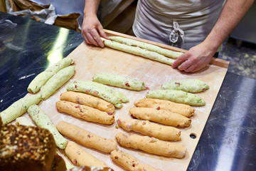 Roll out dough before baking bread in bakery