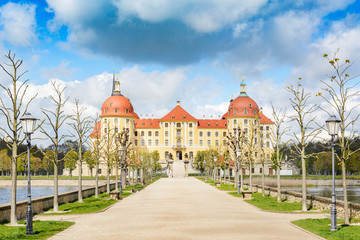 Fototapeta premium Moritzburg Castle in the spring. This famous water castle with beautiful gardens and access road became famous by Czech-German fairytale Cinderella.