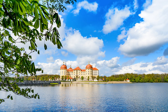 Beautiful photo of Moritzburg Castle in the spring. This famous water castle with beautiful gardens and access road became famous by Czech-German fairytale Cinderella.