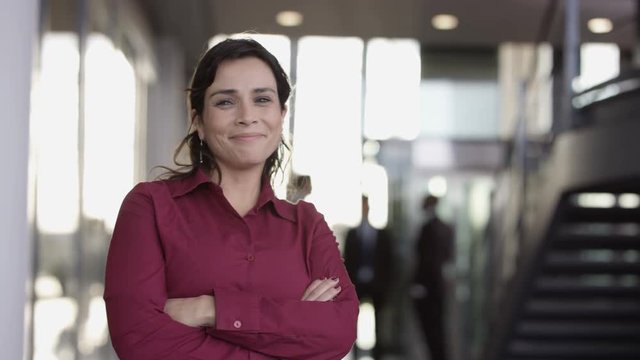  Portrait smiling successful businesswoman in large modern office building
