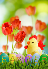 Image of toy chick and Easter eggs in grass closeup