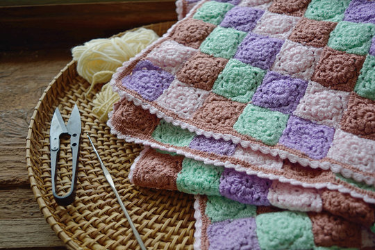 Beautiful vintage handmade crochet and crochet hook,scissors and yarn in a basket