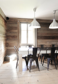 Industrial style dining room in a renovated old wooden chalet